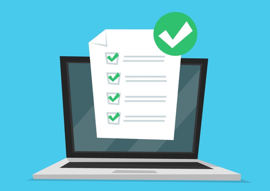 Paperwork on computer with check marks