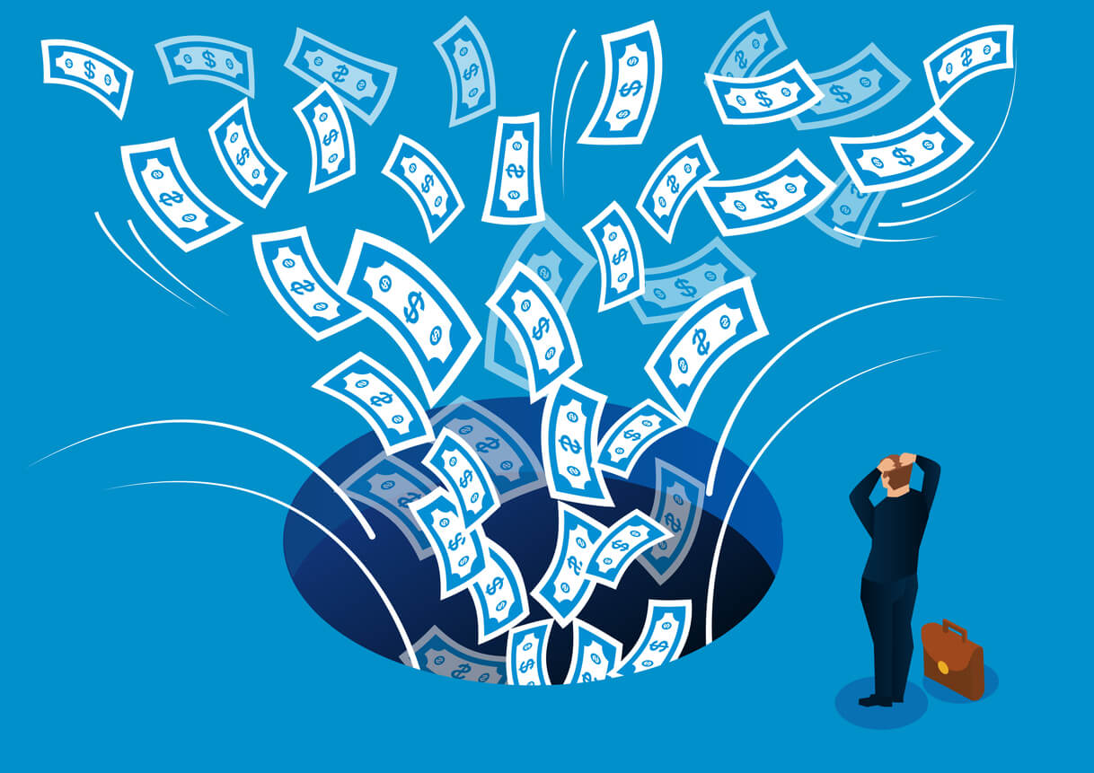 Man stressed about his money being sucked into a hole of bills